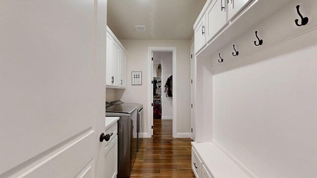 1202 Stonefield Dr, Midland, TX 79706 - laundry area featuring washer and dryer, cabinet space, dark wood-style floors, and baseboards