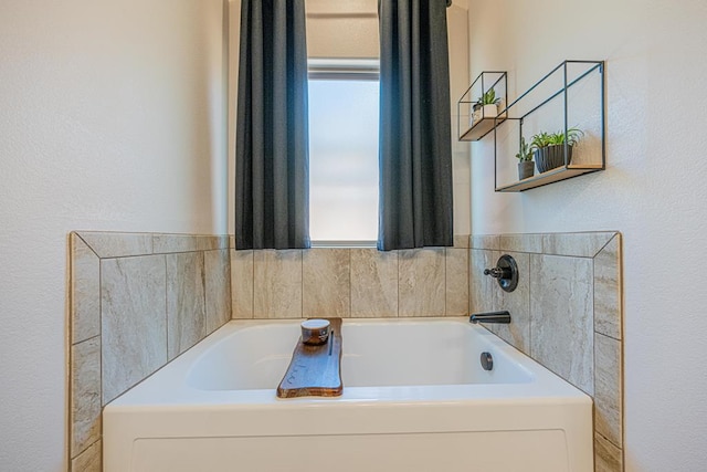 1202 Stonefield Dr, Midland, TX 79706 - bathroom featuring a bath and a textured wall