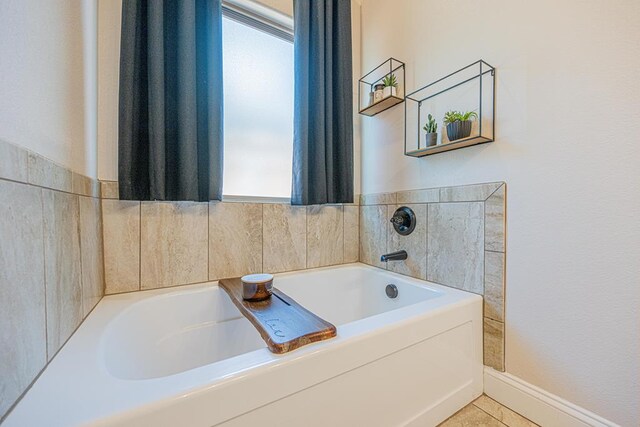 1202 Stonefield Dr, Midland, TX 79706 - bathroom with a bath, tile patterned flooring, and baseboards