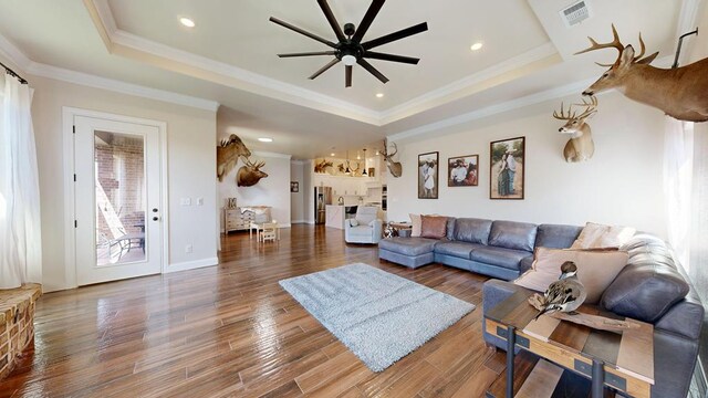 1202 Stonefield Dr, Midland, TX 79706 - living area featuring a tray ceiling, a ceiling fan, crown molding, wood finished floors, and recessed lighting