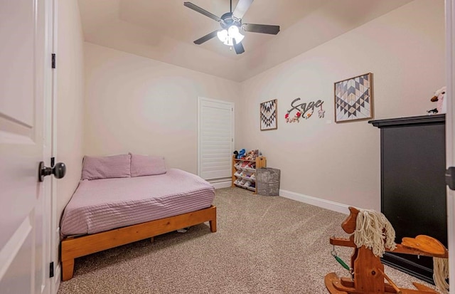 carpeted bedroom featuring ceiling fan and baseboards