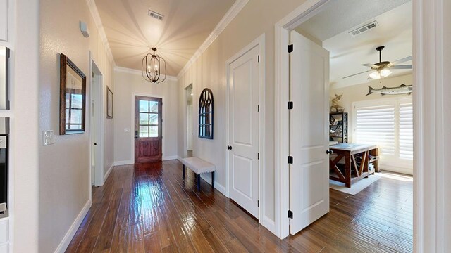 1202 Stonefield Dr, Midland, TX 79706 - entrance foyer featuring a chandelier, dark wood-type flooring, ornamental molding, baseboards, and a ceiling fan