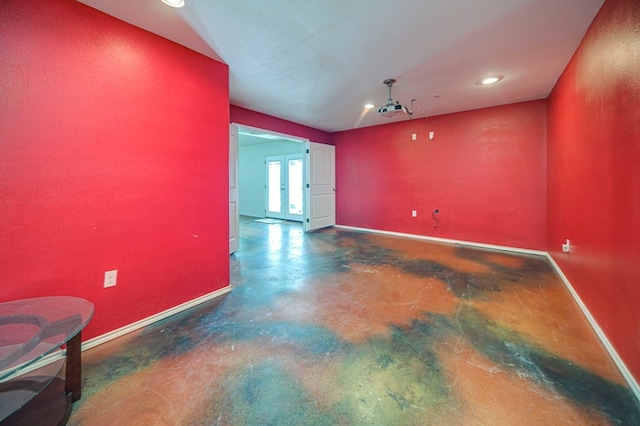 empty room featuring concrete floors and french doors