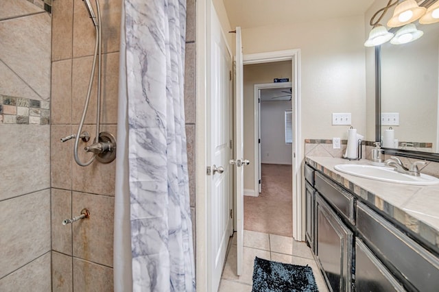 bathroom featuring vanity, tile patterned flooring, and curtained shower