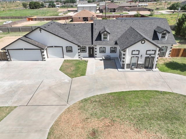 view of front of property featuring a front lawn and a garage