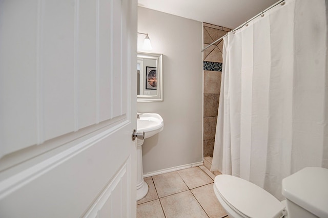 bathroom featuring toilet, tile patterned flooring, and curtained shower