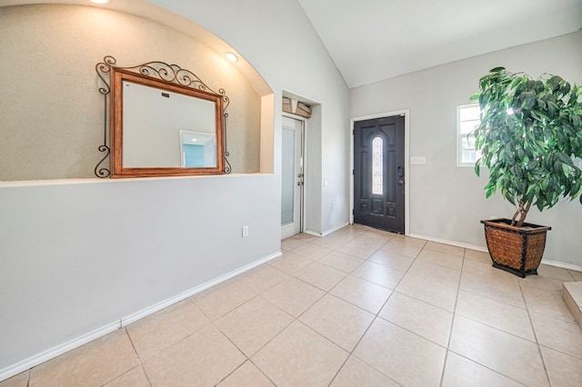 entrance foyer featuring vaulted ceiling and light tile patterned flooring