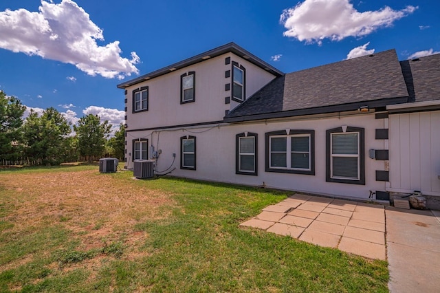 rear view of house with a patio area, a lawn, and central air condition unit