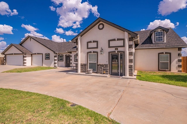 front facade featuring a front lawn and a garage