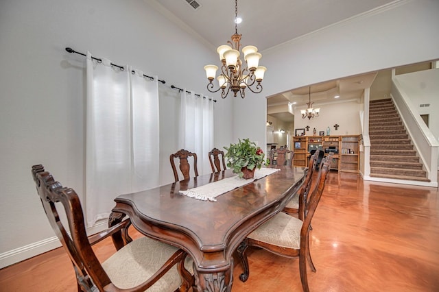 dining area featuring crown molding and a notable chandelier