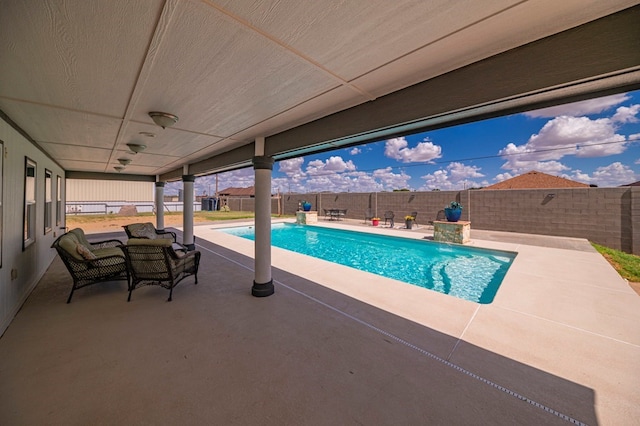 view of swimming pool featuring a patio area