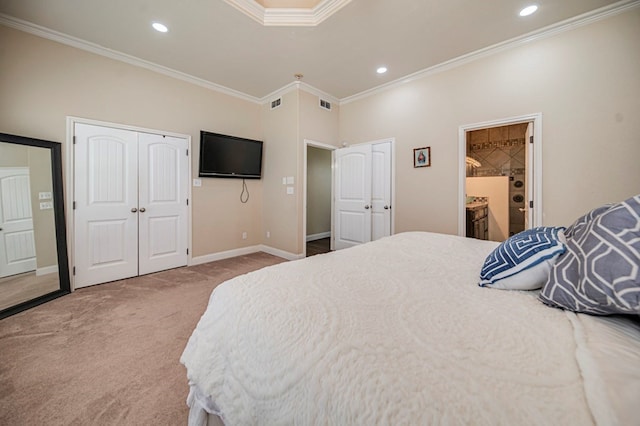 bedroom with ensuite bathroom, ornamental molding, and carpet floors