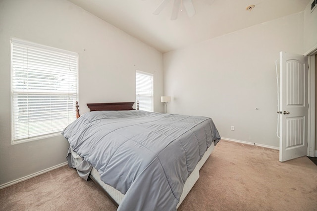 carpeted bedroom featuring ceiling fan and vaulted ceiling