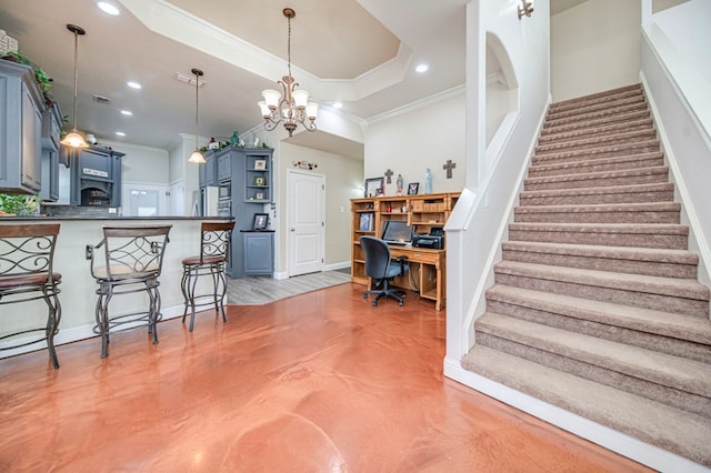 interior space featuring a breakfast bar, kitchen peninsula, crown molding, a tray ceiling, and blue cabinets