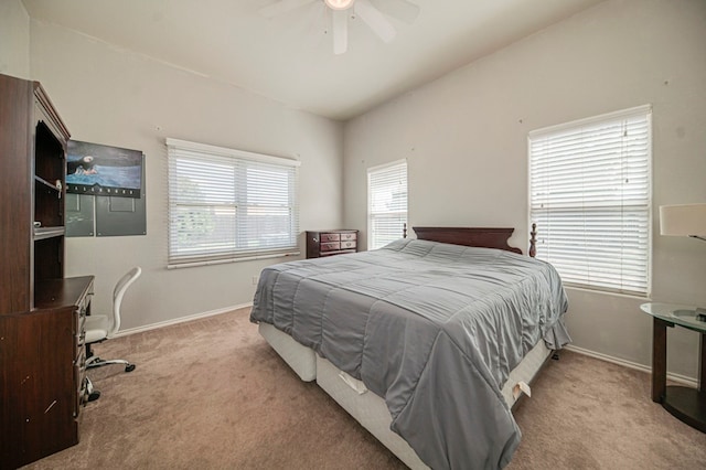 bedroom with ceiling fan, lofted ceiling, and light colored carpet