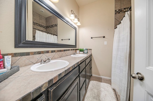 bathroom featuring tile patterned flooring, backsplash, and vanity