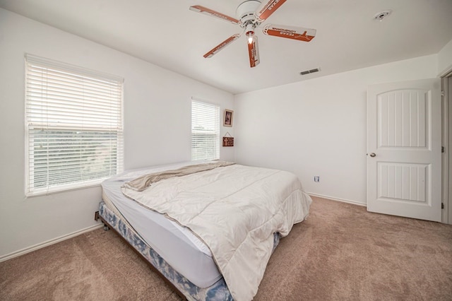 bedroom featuring ceiling fan and light carpet