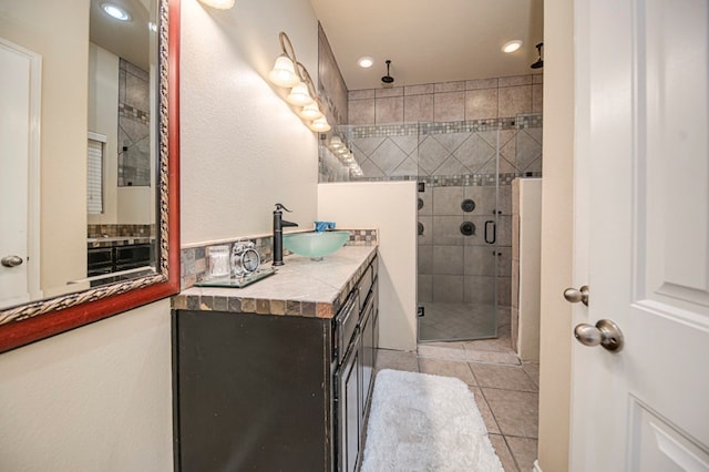 bathroom featuring an enclosed shower, vanity, and tile patterned flooring