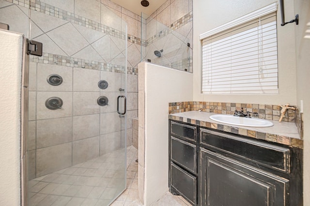 bathroom with sink, tile patterned floors, and a shower with door