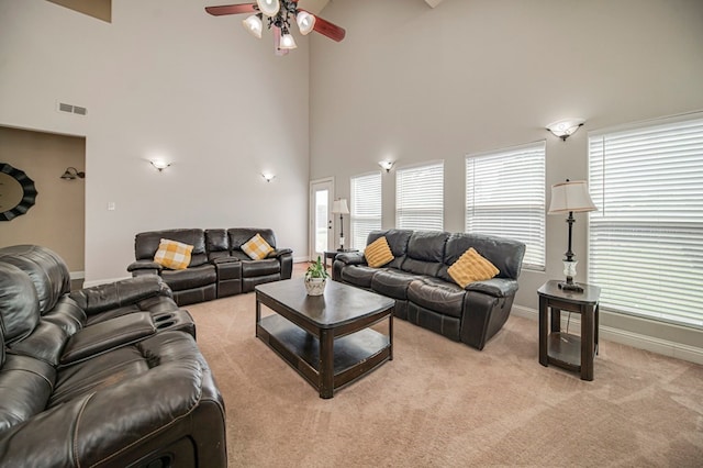 carpeted living room featuring ceiling fan and high vaulted ceiling