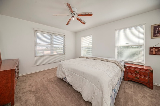 bedroom featuring ceiling fan and light carpet