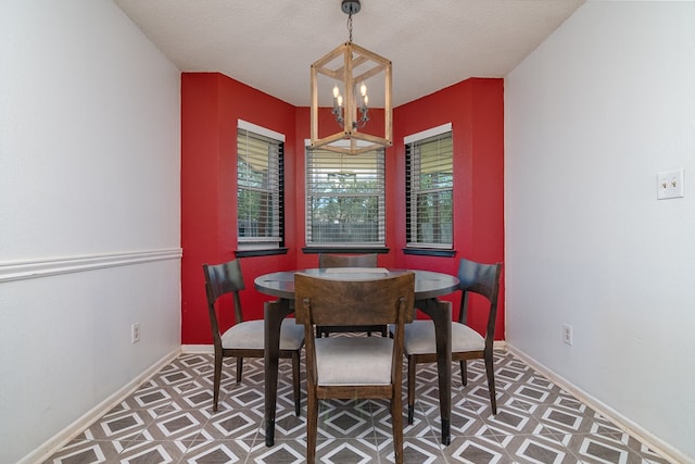 1604 Mcdonald St, Midland, TX 79703 - dining room featuring a chandelier, tile patterned floors, and a textured ceiling