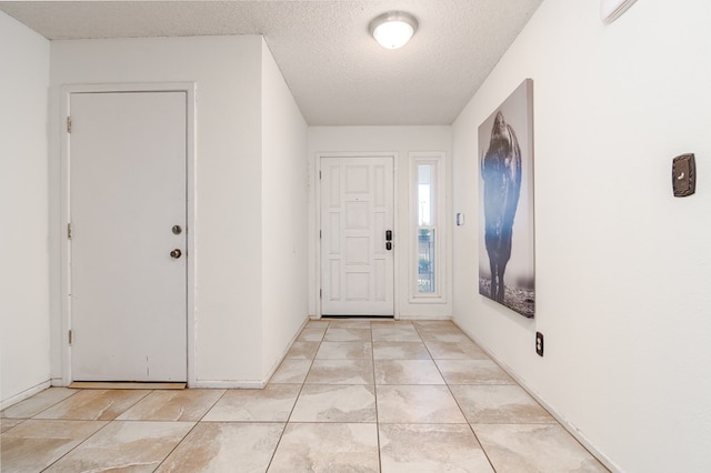 1604 Mcdonald St, Midland, TX 79703 - foyer entrance featuring a textured ceiling and light tile patterned floors