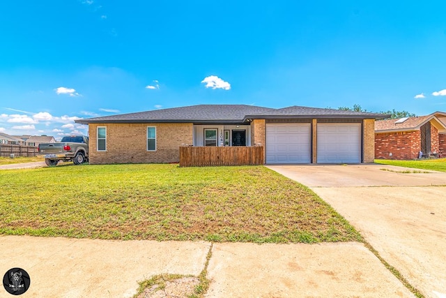 1604 Mcdonald St, Midland, TX 79703 - single story home with brick siding, a garage, and driveway