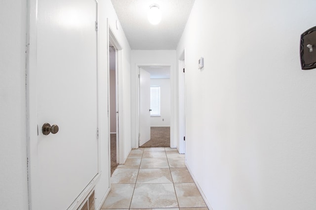 1604 Mcdonald St, Midland, TX 79703 - hall featuring a textured ceiling and light tile patterned floors
