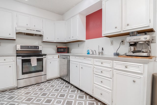 1604 Mcdonald St, Midland, TX 79703 - kitchen featuring stainless steel appliances, under cabinet range hood, light countertops, and white cabinets