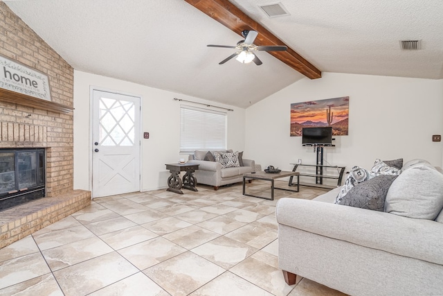 1604 Mcdonald St, Midland, TX 79703 - living room with ceiling fan, a brick fireplace, light tile patterned floors, and a textured ceiling