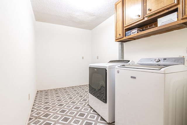1604 Mcdonald St, Midland, TX 79703 - laundry room with cabinet space, washing machine and clothes dryer, a textured ceiling, and light flooring