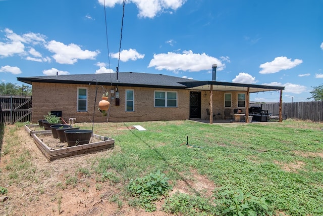 1604 Mcdonald St, Midland, TX 79703 - rear view of property featuring a garden, a fenced backyard, a patio, and brick siding