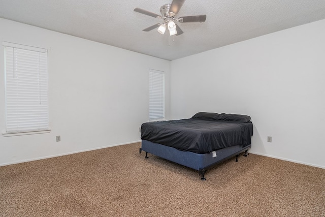 1604 Mcdonald St, Midland, TX 79703 - carpeted bedroom with a ceiling fan and a textured ceiling