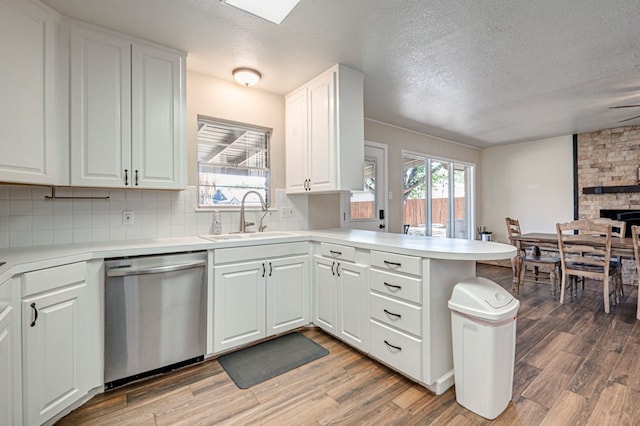 2006 Ward St, Midland, TX 79705 - kitchen featuring a peninsula, dishwasher, light countertops, a sink, and backsplash