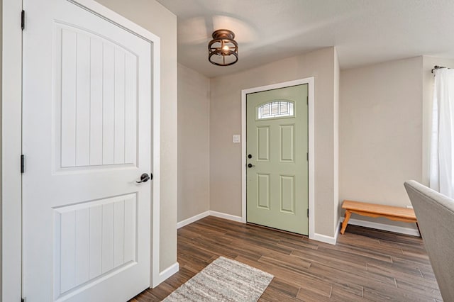 entrance foyer featuring baseboards and wood finished floors