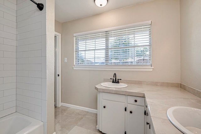 full bath with double vanity, plenty of natural light, and a sink