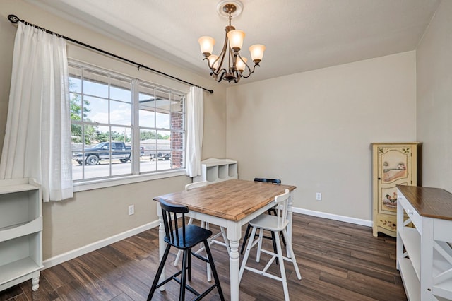 dining space featuring baseboards, an inviting chandelier, and dark wood-style floors