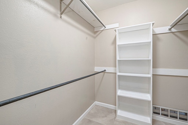 spacious closet featuring tile patterned floors and visible vents