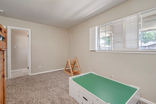 game room with carpet floors, baseboards, and a wealth of natural light