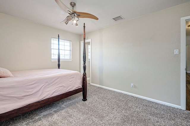 carpeted bedroom with baseboards, a ceiling fan, and visible vents