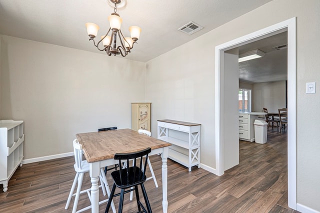 dining room featuring baseboards, an inviting chandelier, dark wood finished floors, and visible vents