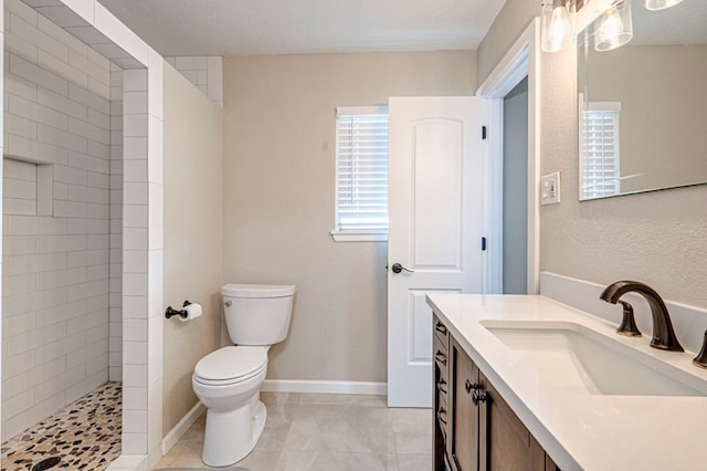 bathroom with a walk in shower, tile patterned flooring, vanity, and toilet