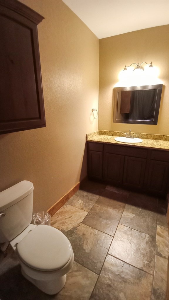 bathroom featuring vanity and toilet