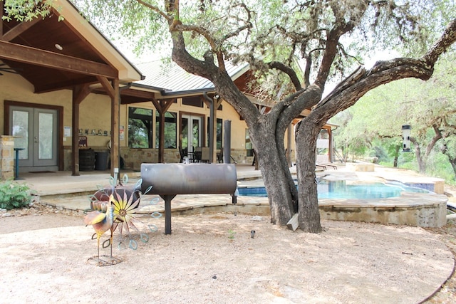 view of yard with a patio and french doors