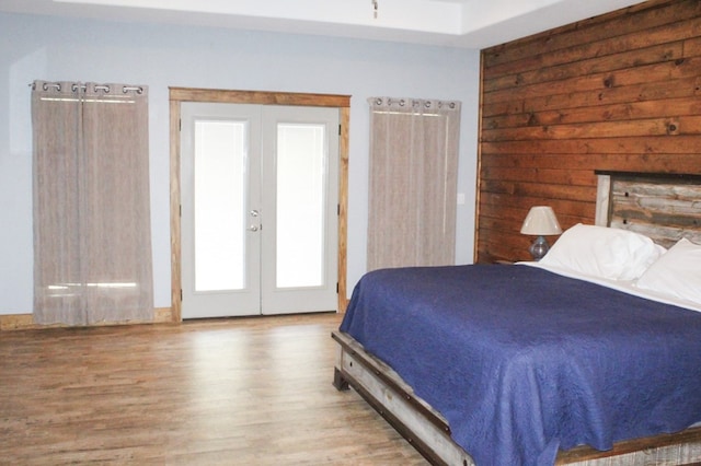 bedroom featuring french doors and light hardwood / wood-style floors