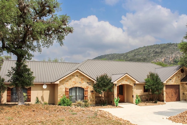 view of front of house featuring a mountain view and a garage