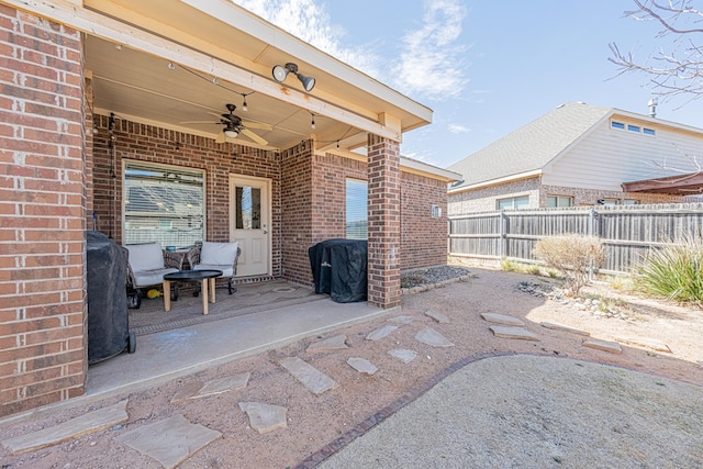 view of patio / terrace featuring fence and a ceiling fan