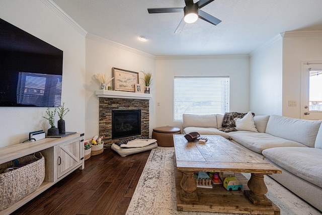 living room featuring ornamental molding, dark wood-style flooring, a fireplace, and plenty of natural light