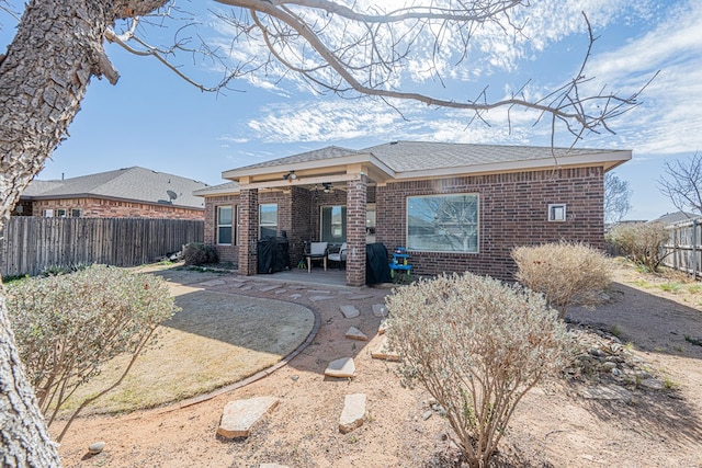 back of property featuring a patio, brick siding, a fenced backyard, and a ceiling fan